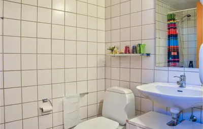 a bathroom with a toilet and a sink at 2 Bedroom Lovely Apartment In Lemvig in Lemvig