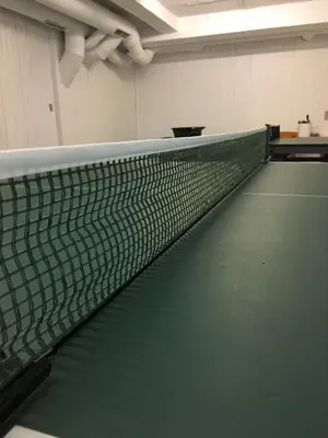 a tennis court with a net in a room at Idrætscenter Jammerbugt in Fjerritslev
