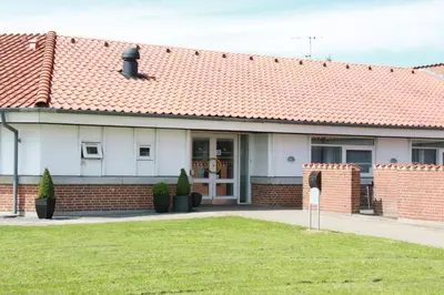 a brick house with a red roof at Motel Spar 10 in Viborg