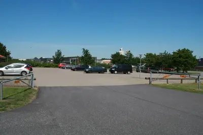 a parking lot with a bunch of cars parked at Motel Spar 10 in Viborg