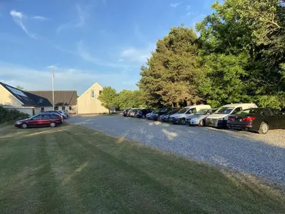 a row of cars parked on the side of a road at Guesthouse Hune in Blokhus