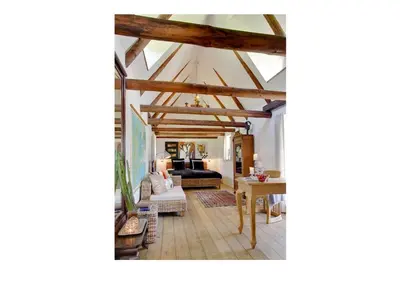 a living room with a ceiling with wooden beams at Holmsminde in Viborg