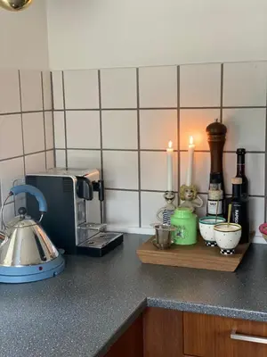 a kitchen counter with a counter top with a microwave at Holmsminde in Viborg