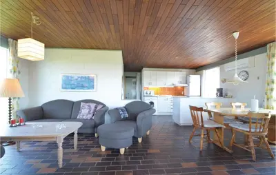 a living room with a couch and a table at Three-Bedroom Holiday Home In Frostrup in Frøstrup