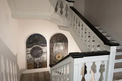 a staircase with white railings and a painting on the wall at Vitskøl Kloster in Ranum