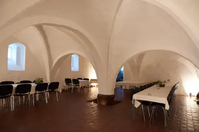 a room with tables and chairs in a building at Vitskøl Kloster in Ranum
