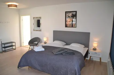 a bedroom with a large bed with two pillows at Thyborøn Hotel in Thyborøn