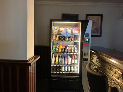 a refrigerator filled with lots of sodas and drinks at Thyborøn Hotel in Thyborøn