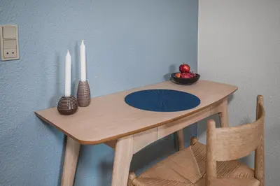 a table with two candles and a bowl of fruit on it at Hotel Højgaarden in Slettestrand