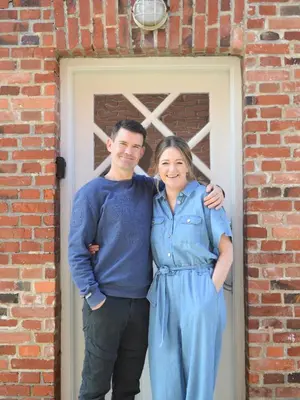 a man and a woman standing in front of a door at Bredgade 10 Thyborøn in Thyborøn
