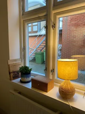 a lamp sitting on a window sill next to a window at Bredgade 10 Thyborøn in Thyborøn