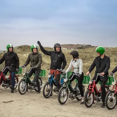 a group of people riding bikes on a dirt road at Bredgade 10 Thyborøn in Thyborøn