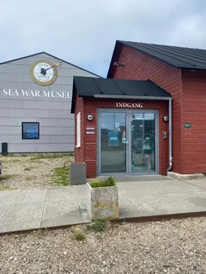 a red building with the entrance to asea war museum at Bredgade 10 Thyborøn in Thyborøn