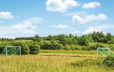 a field with two soccer goals in a field at Four-Bedroom Holiday Home In Lokken in Løkken