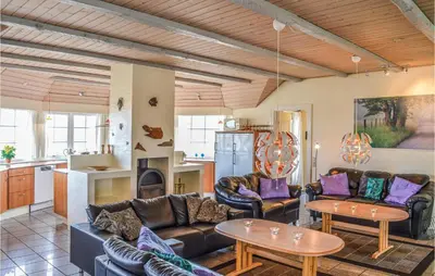 a living room with couches and tables and a kitchen at Nice Home In Harboøre With Kitchen in Harboør