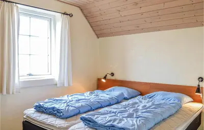 a bedroom with two beds and a window at Nice Home In Harboøre With Kitchen in Harboør