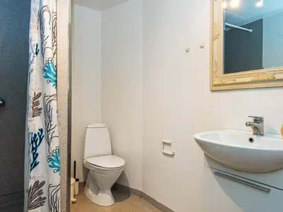 a bathroom with a toilet and a sink and a mirror at 4 person holiday home in Thyborøn-By Traum in Thyborøn