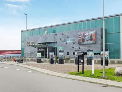 a large building with people standing outside of it at 4 person holiday home in Thyborøn-By Traum in Thyborøn