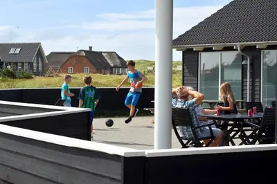 a group of people playing a game of basketball at Luksus-poolhus B5 in Harboør