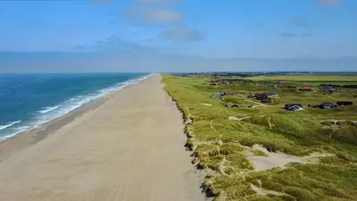 an aerial view of a beach and the ocean at Luksus-poolhus B5 in Harboør