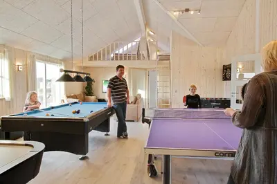 a group of people in a room with pool tables at Luksus-poolhus L21 in Harboør