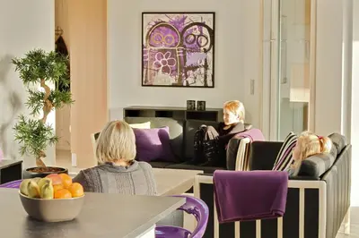 a group of people sitting in chairs in a room at Luksus-poolhus L21 in Harboør