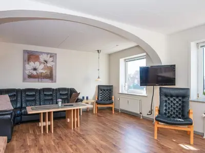 a living room with leather furniture and a flat screen tv at 6 person holiday home in Thyborøn in Thyborøn