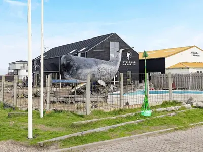 a statue of a chicken in front of a building at 6 person holiday home in Thyborøn in Thyborøn