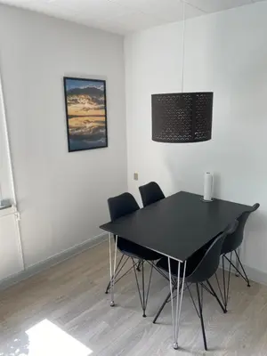 a black dining room table and chairs in a room at Hel lejlighed Thisted Midtby in Thisted