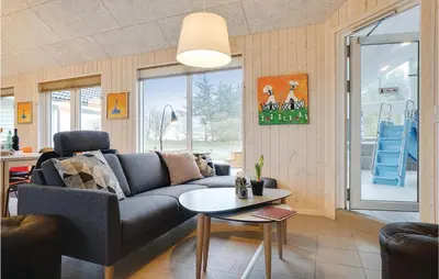 a living room with a couch and a table at 9 Bedroom Beautiful Home In Spøttrup in Spottrup