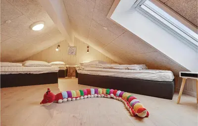 a bedroom with two beds and a toy on the floor at 9 Bedroom Beautiful Home In Spøttrup in Spottrup