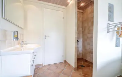 a bathroom with a sink and a shower at Three-Bedroom Holiday Home In Vinderup in Vinderup