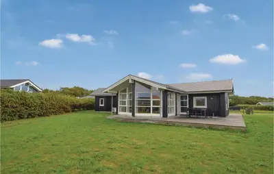a small black house with a large yard at Three-Bedroom Holiday Home In Vinderup in Vinderup