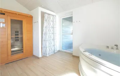 a bathroom with a tub and a large window at Eight-Bedroom Holiday Home In Vestervig in Vestervig