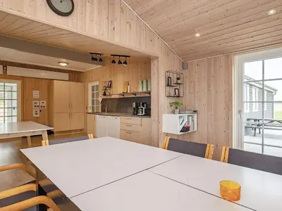 a kitchen with a table and chairs in a room at 24 person holiday home in Øster Assels in Øster Assels
