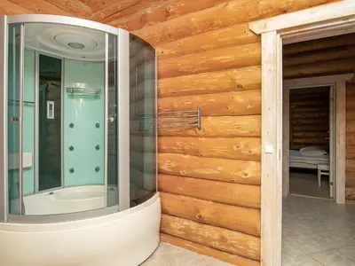 a bathroom with a glass shower in a wooden wall at 10 person holiday home in Frøstrup-By Traum in Frøstrup