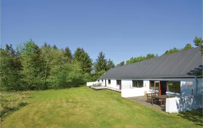 a house with a large yard in front of it at Three-Bedroom Holiday Home In Frostrup in Frøstrup