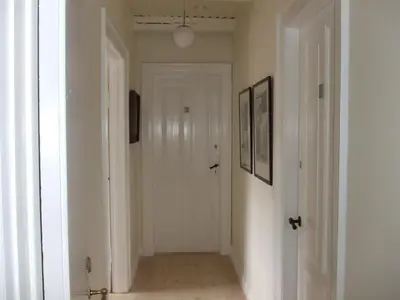 an empty hallway with a white door in a room at Nattely I Viborg By in Viborg