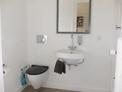 a bathroom with a sink and a toilet and a mirror at Nattely I Viborg By in Viborg