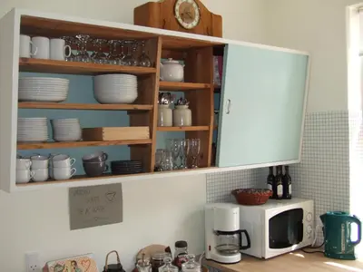 a kitchen with a microwave and a counter with dishes at Nattely I Viborg By in Viborg