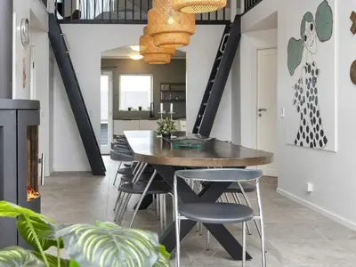 a dining room with a wooden table and chairs at 18 person holiday home in Harboøre in Harboør