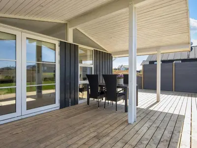 a patio with a table and chairs on a deck at 6 person holiday home in Lemvig in Lemvig