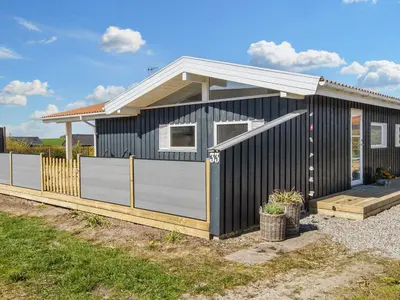 a black and white house with a fence at 6 person holiday home in Lemvig in Lemvig