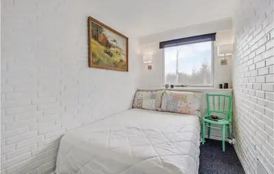 a small bedroom with a bed and a window at Two-Bedroom Holiday Home In Spottrup in Spottrup