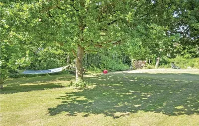 a hammock under a tree in a yard at Two-Bedroom Holiday Home In Spottrup in Spottrup