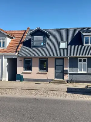 a house with a tin roof on a street at 