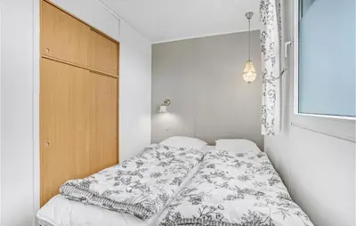 a bedroom with a bed with a white bedspread at Three-Bedroom Holiday Home In Lemvig in Lemvig