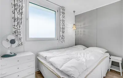 a white bedroom with a bed and a window at Three-Bedroom Holiday Home In Lemvig in Lemvig