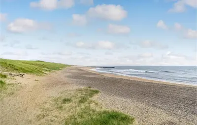 a dirt road leading to the ocean on a beach at Three-Bedroom Holiday Home In Lemvig in Lemvig