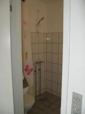 a bathroom with a toilet and a shower at Motel Europa in Svenstrup